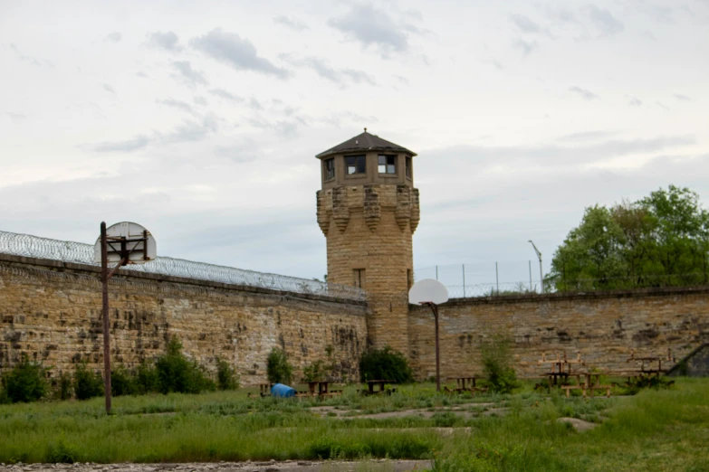 an old fashioned basketball hoop sitting near a large brick building