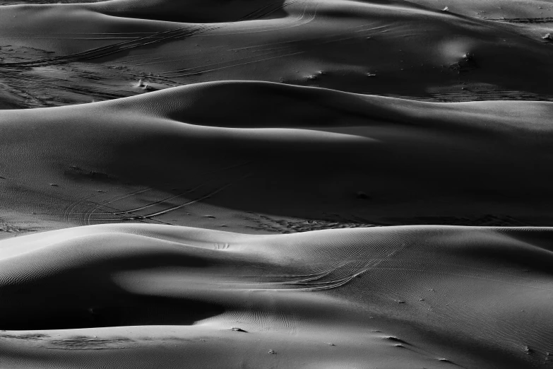 a po of sand dunes taken in black and white