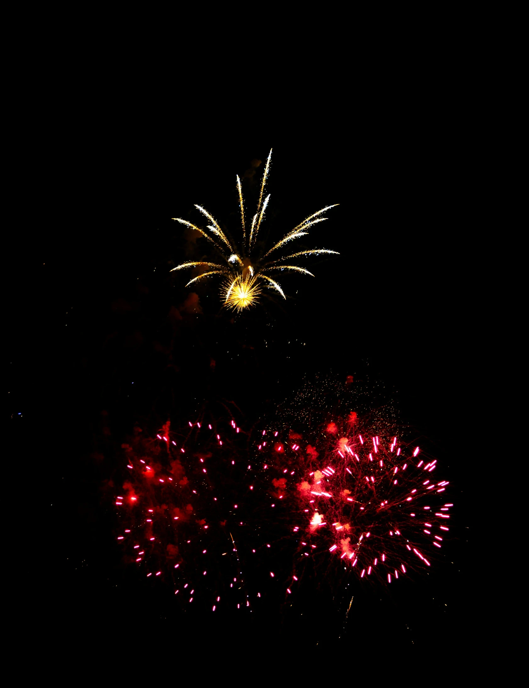 a bright red and white fireworks show over the city