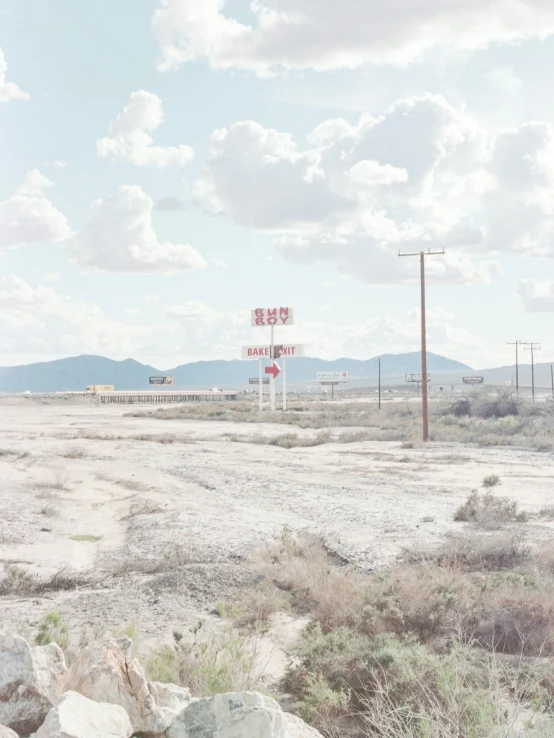 a rock pile in front of some dirt and an intersection sign