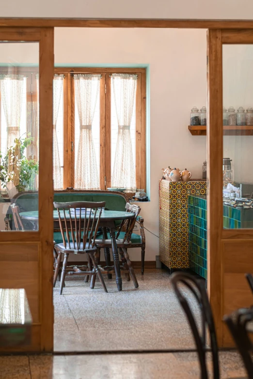 the view of the kitchen through the glass doors of a dining room