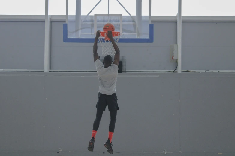 a man is playing basketball on an outdoor court