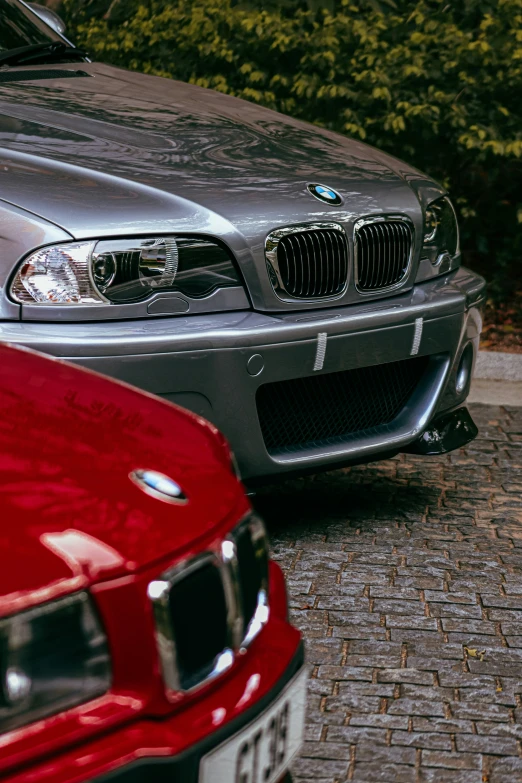 two silver and red cars parked side by side