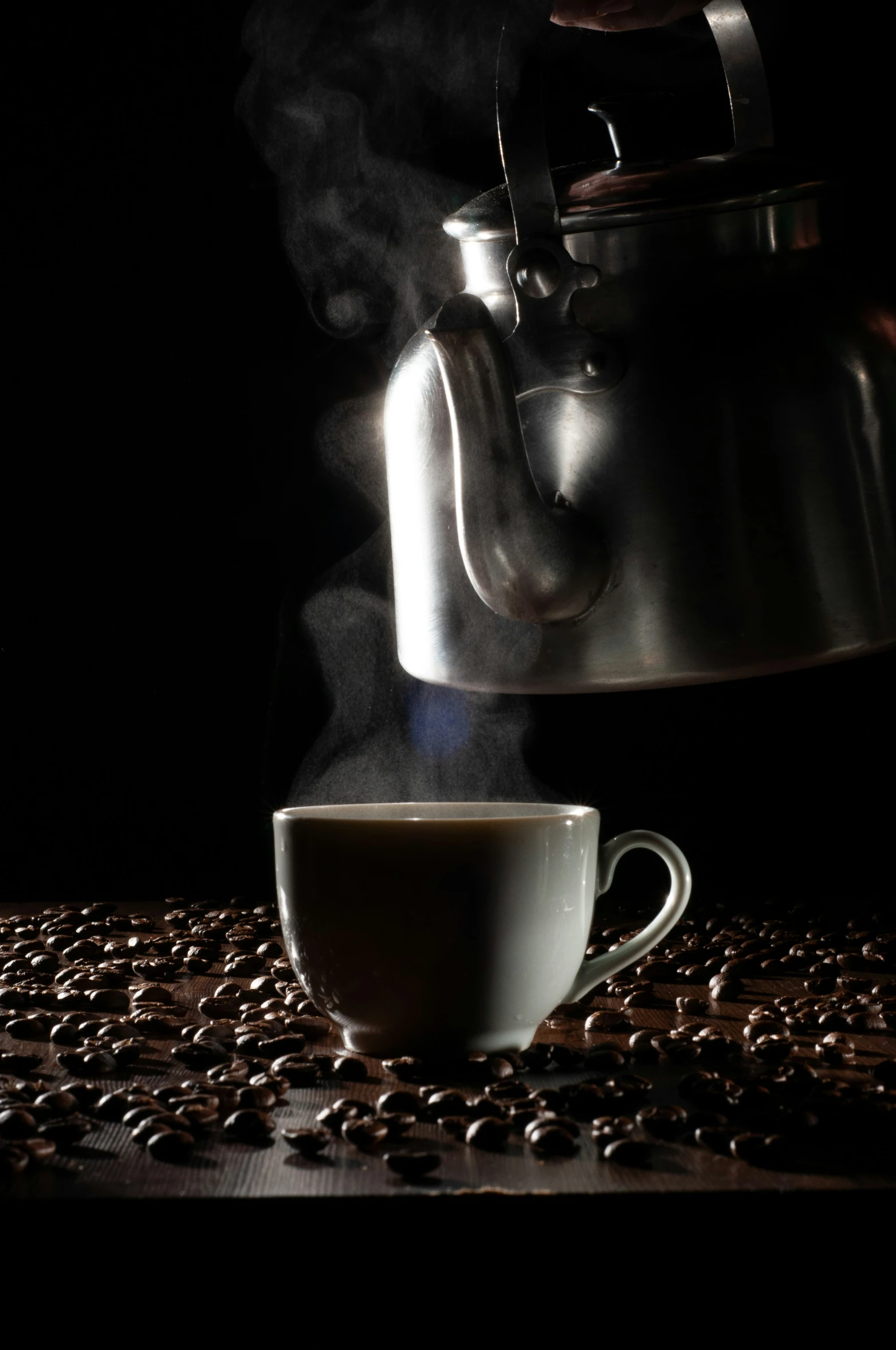 a steaming cup of coffee sitting on a table with coffee beans