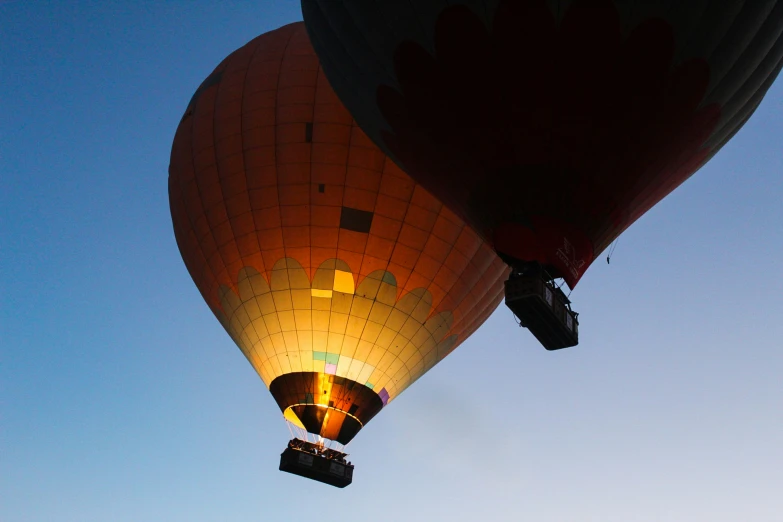 two  air balloons flying in the sky