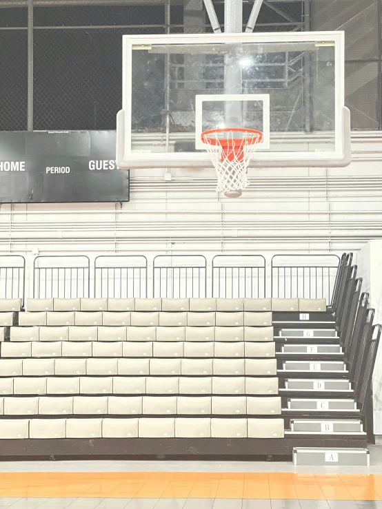 empty empty benches near the basketball hoop in a basketball gym