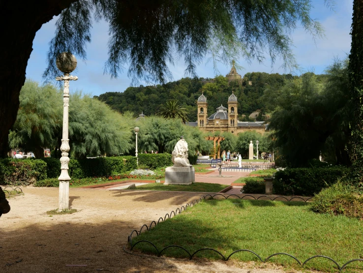 an ornate view of a park and building from some distance