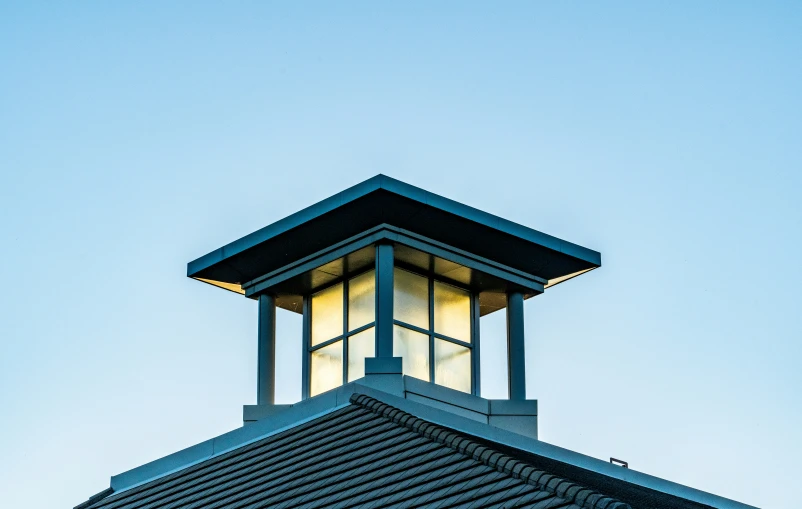 a light tower lit up at night on top of the roof