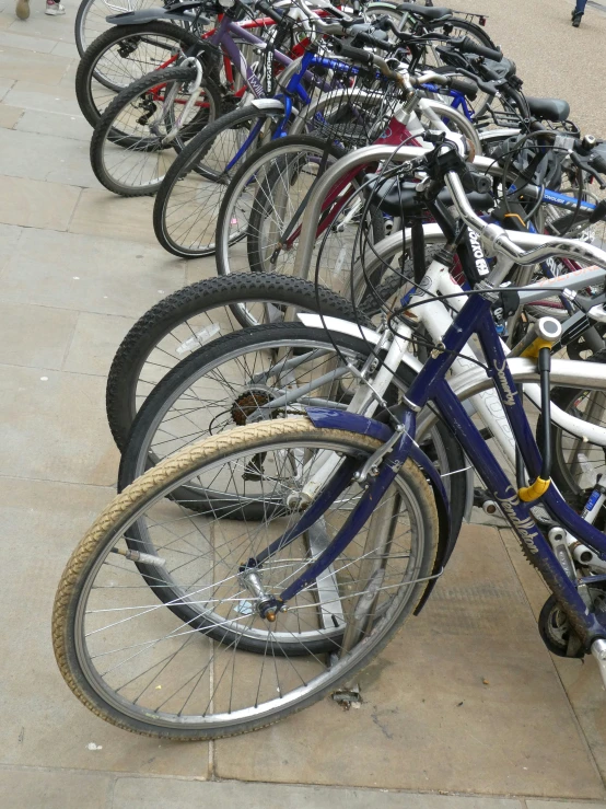 a bunch of bikes are standing side by side