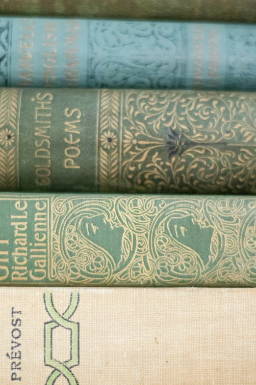 four books sit in front of a table