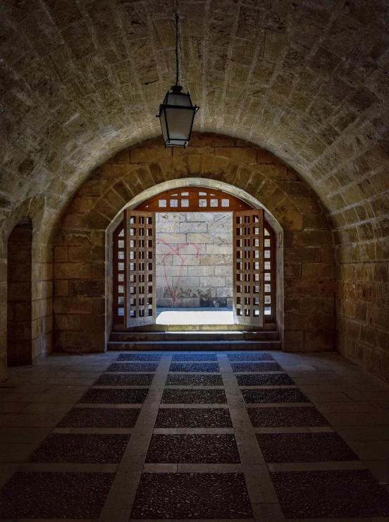 a light is on in the middle of an arch