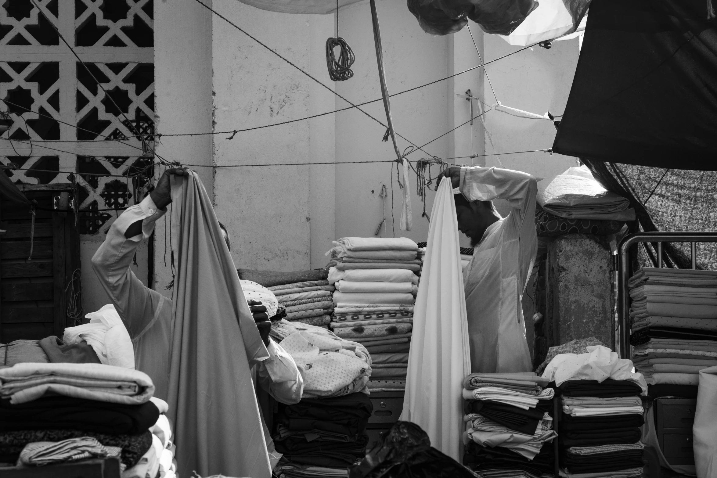 an open closet full of different colored fabrics