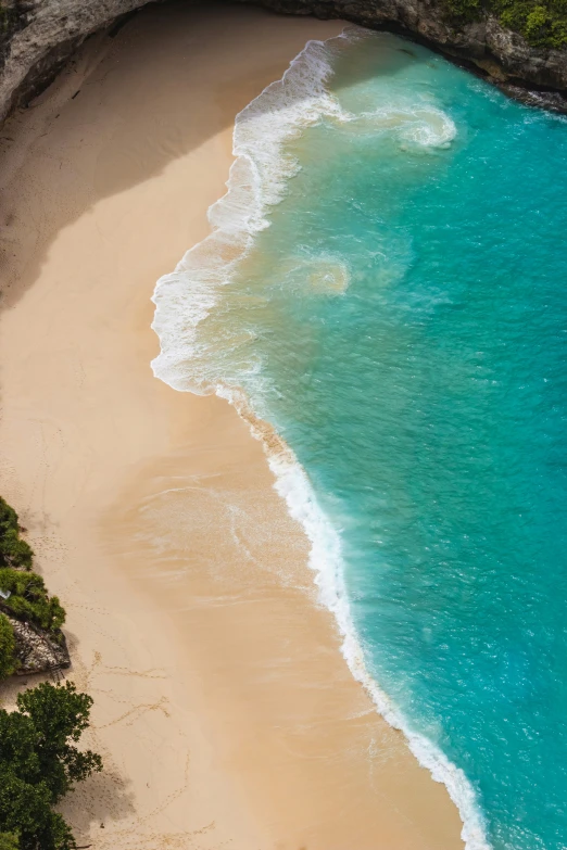 blue water under a cliff next to an ocean