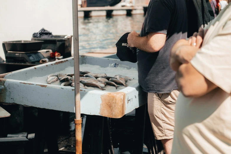 people preparing food in a boat at a harbor