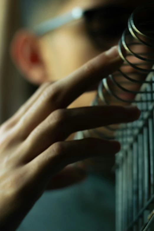 a man touching the wire on top of a shelf