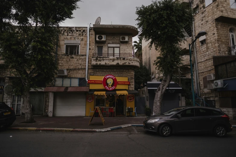 a tall brick building with a pizza sign on top of it