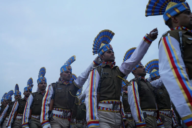 there are many indian men in uniform on the street