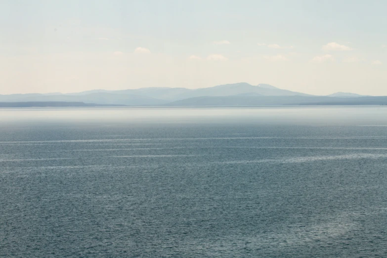 the blue water is calm and has small white dots in it