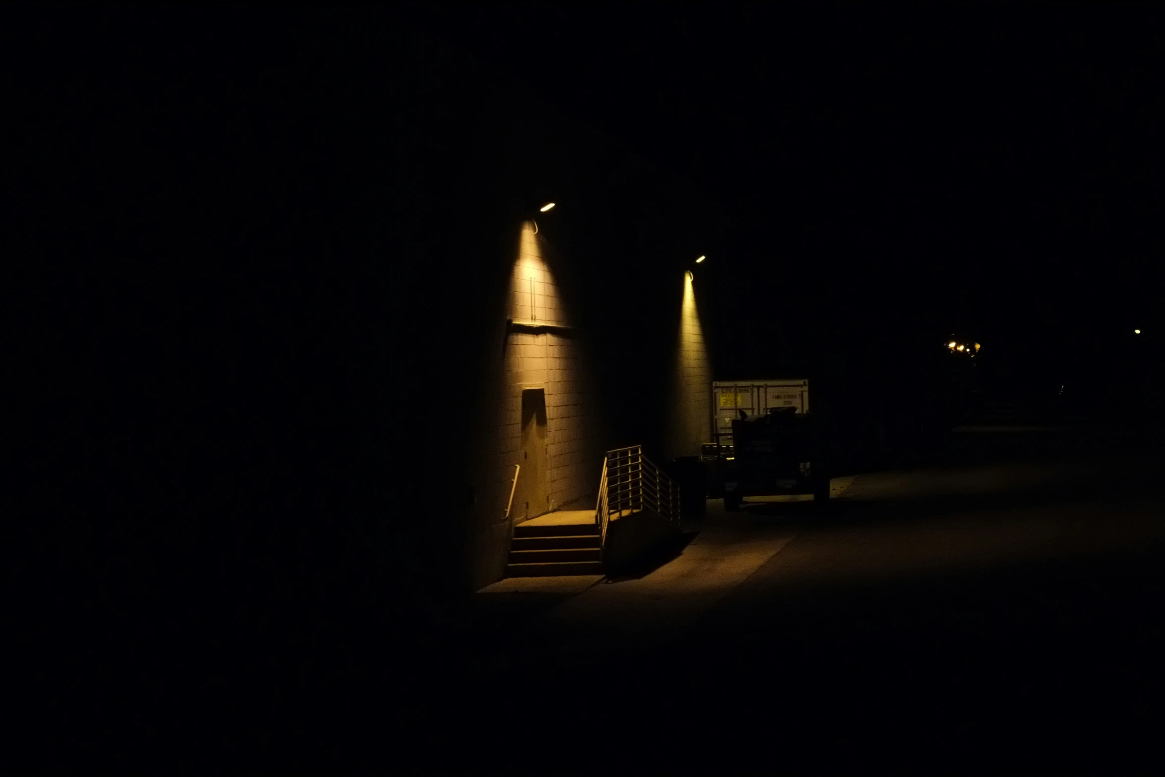 an image of some lights by the staircase at night