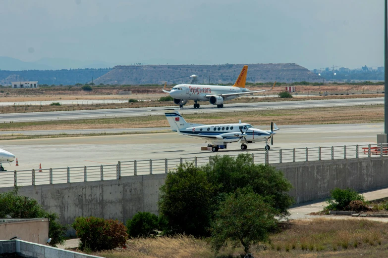 three airplanes at an airport on a runway