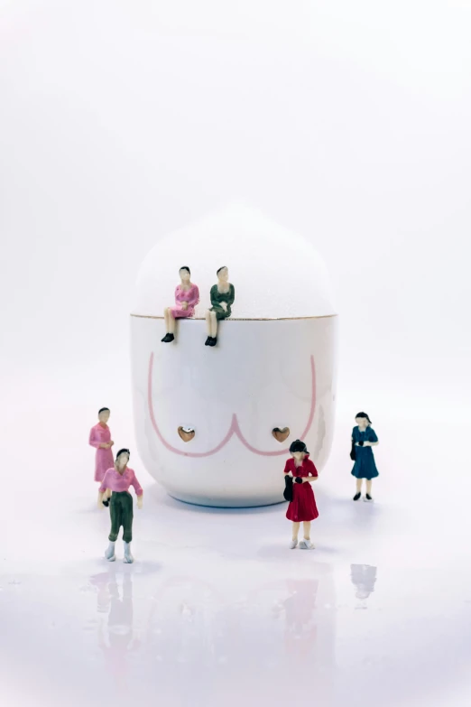miniature people are placed in the shape of a bowl