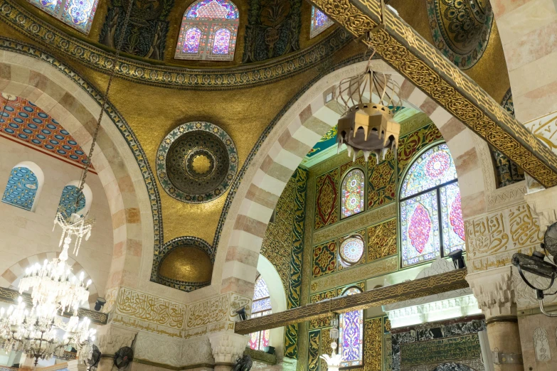 colorful stained glass windows and walls inside of a building