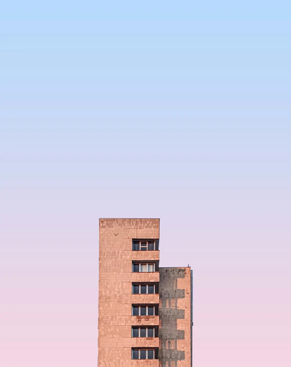 a tall building in front of blue sky