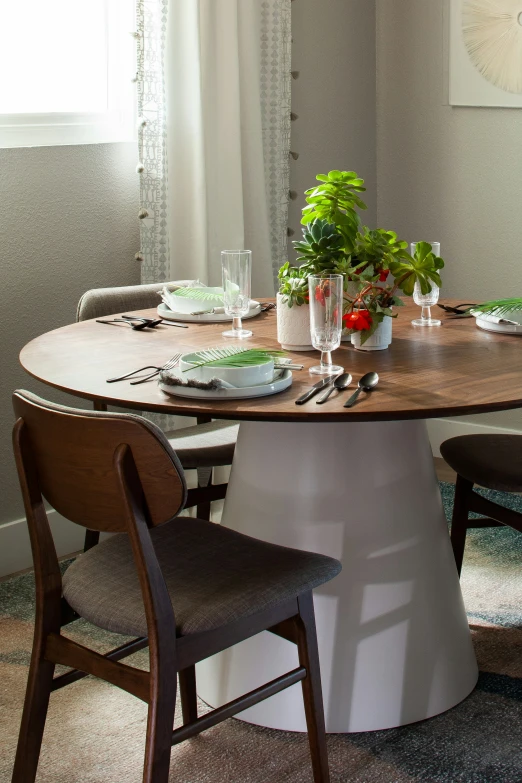 an oval wooden table in a small dining room