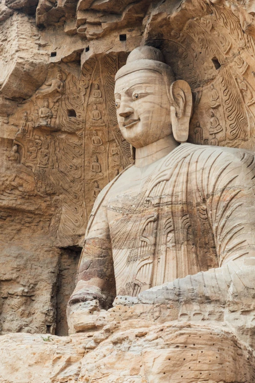 the buddha statue is carved out of the rock