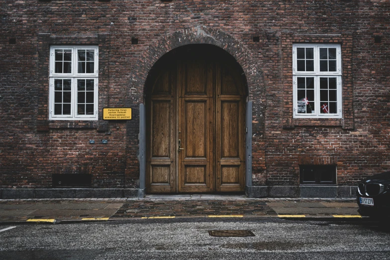 a large brown door in a brick building