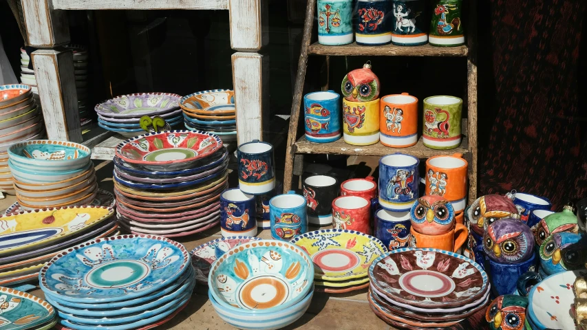 colorful plates sitting on the side of a table