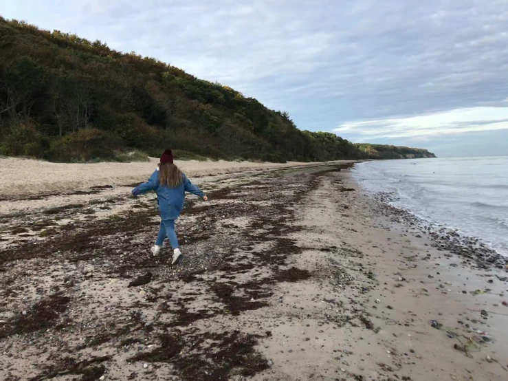  running through wet mud towards the ocean