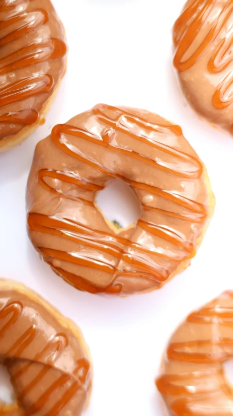 many donuts with frosting on top of each other