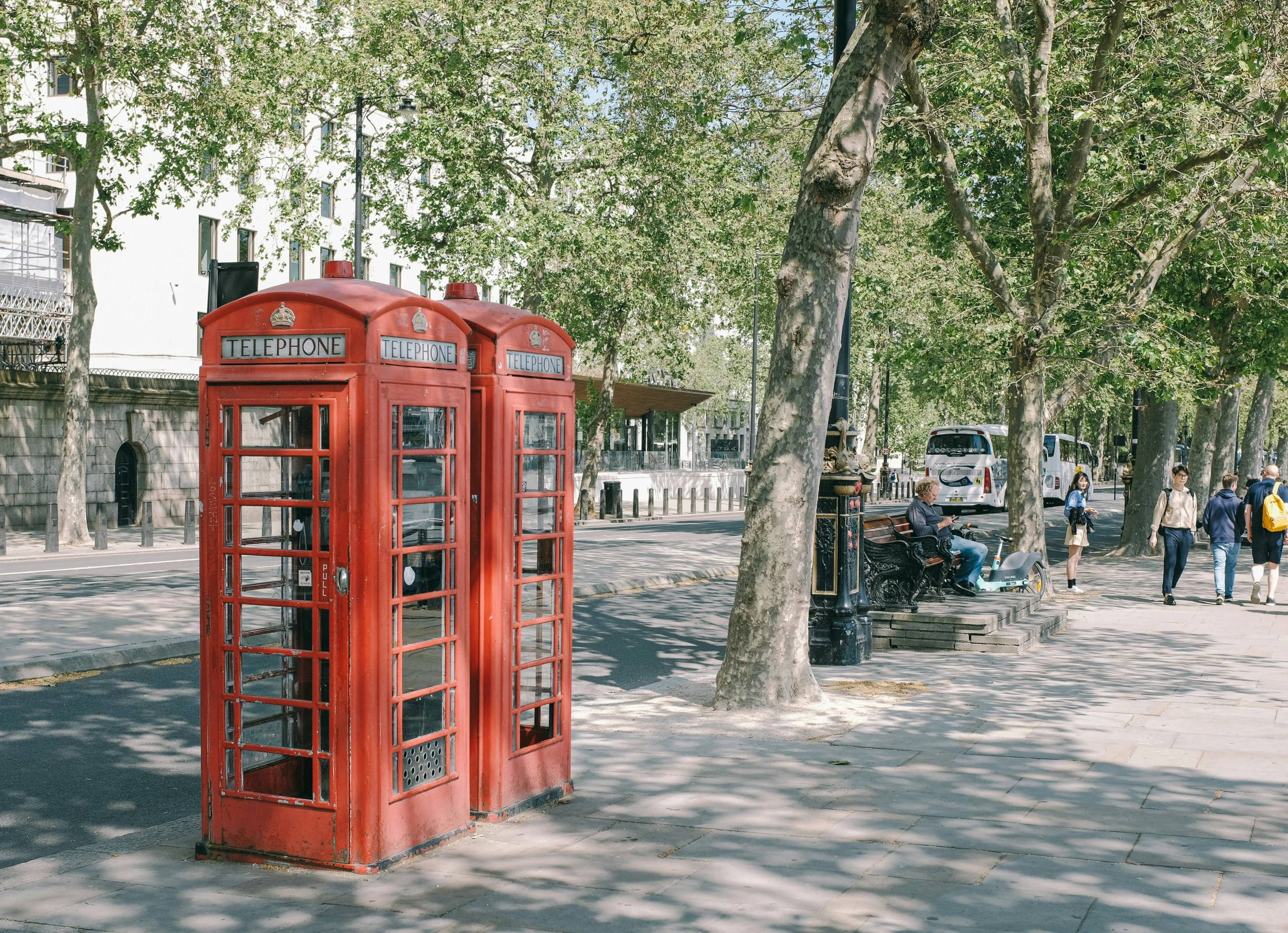 a red telephone booth on the corner of a street