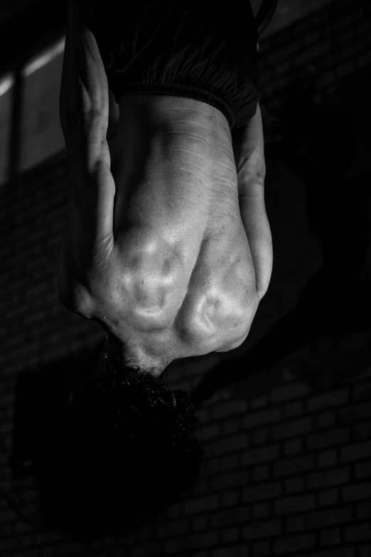 a person in shorts and a black shirt with a white paint painted on his hand