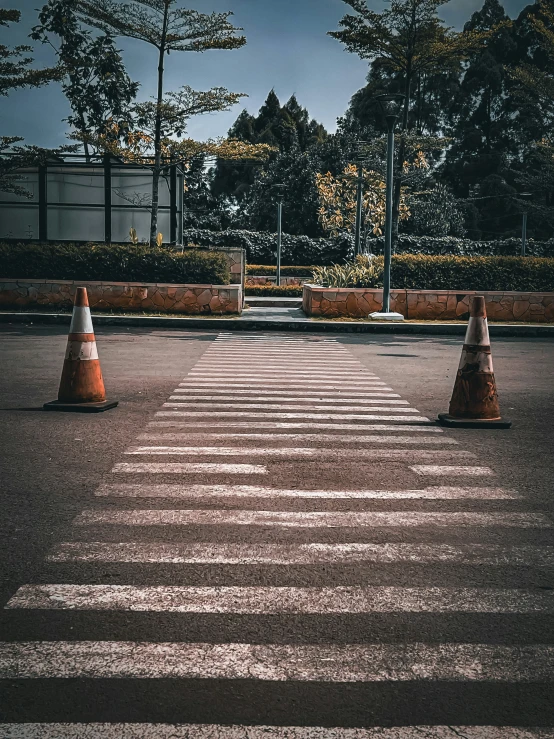 several cones are placed in the middle of a paved lot