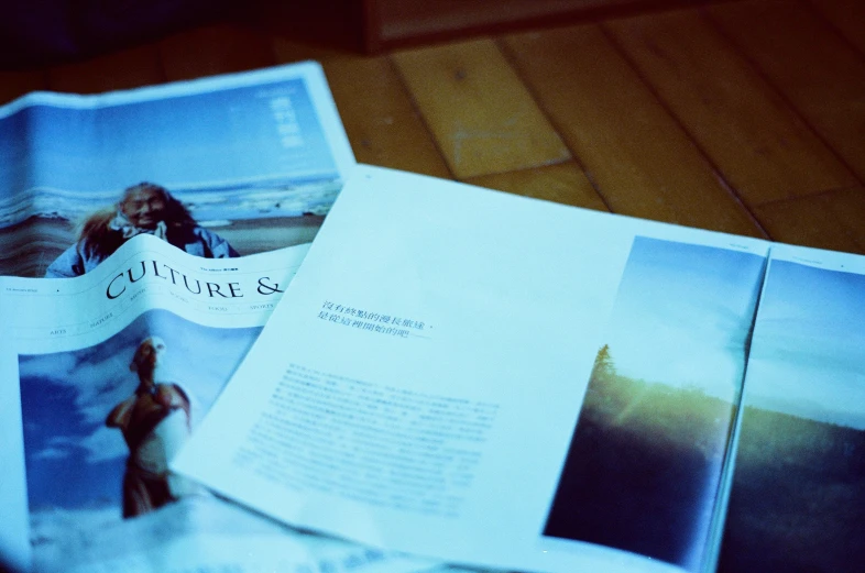 an open magazine lying on top of a wooden table