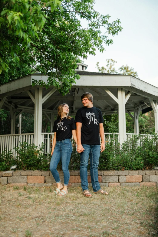 two people standing in front of a gazebo