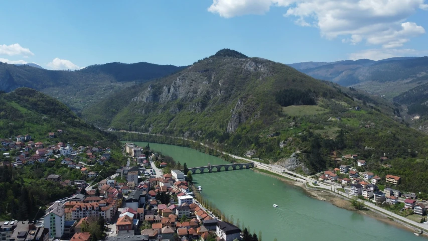 a river with a city in the center surrounded by mountains