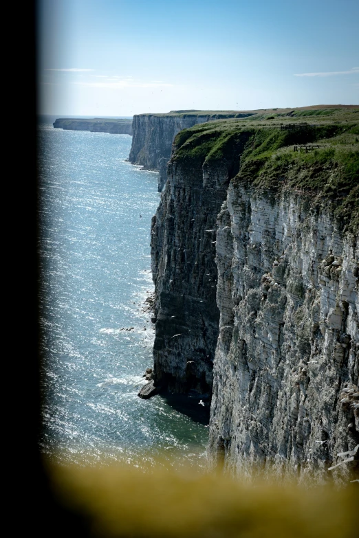 the ocean is partially closed and there are two cliffs sticking out to sea