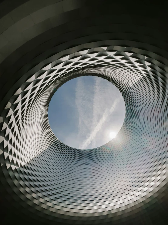 a circular object in a building surrounded by tall grass