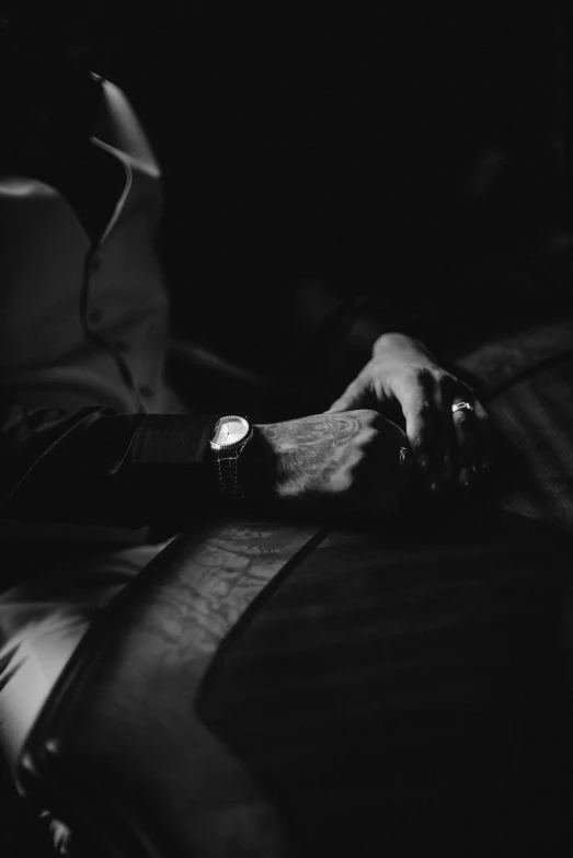 a close up of a person on a bed with a clock