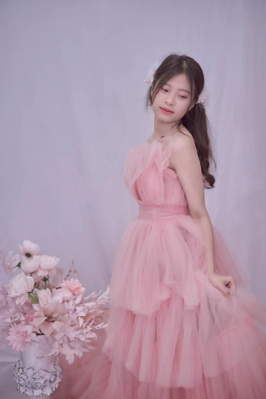 an asian girl in a pink dress and flowers