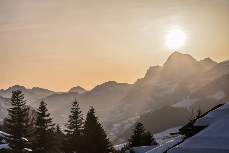 a person skiing with the sun setting in the background