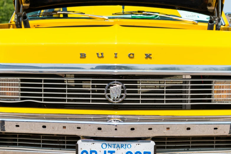 a closeup s of the front of a yellow truck