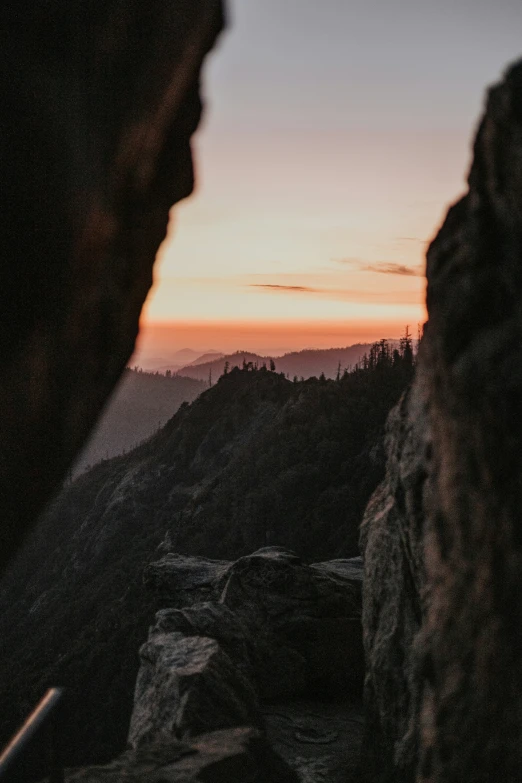 a view from a mountain at sunset with the sky above