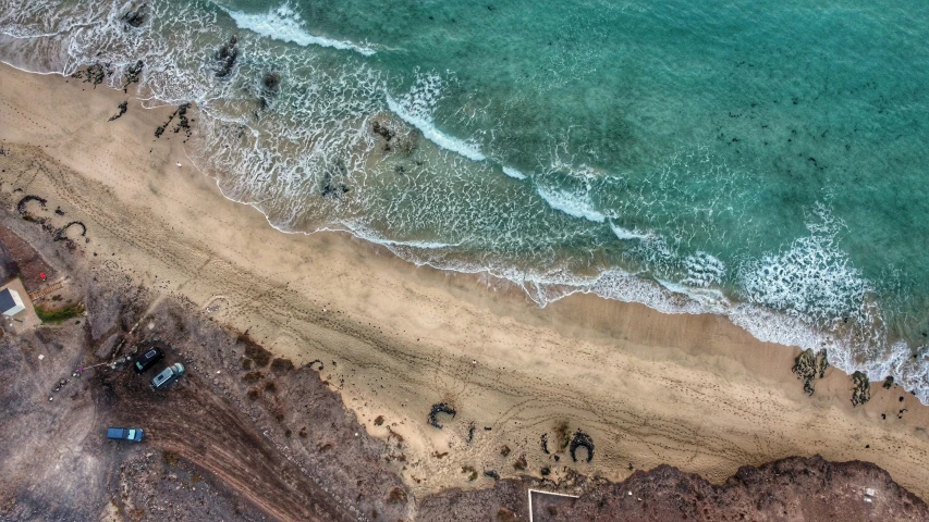 an aerial view of the beach and water