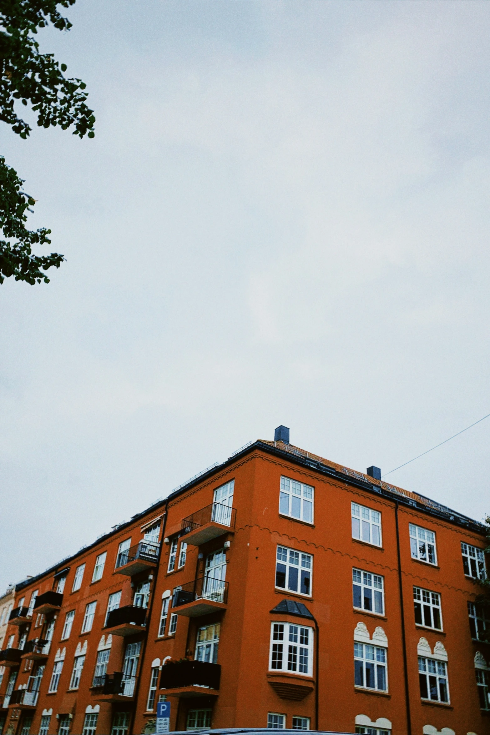 an apartment building with multiple balconies and a clock tower