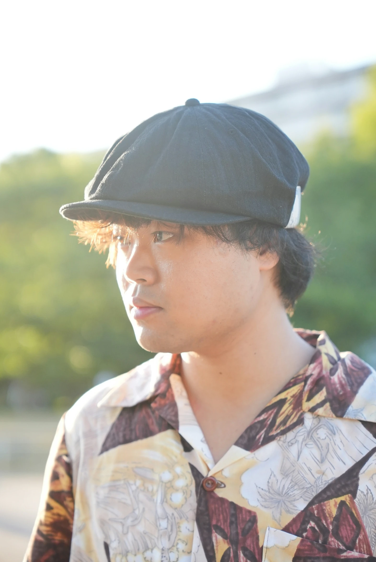 a boy wearing a black hat stares intently