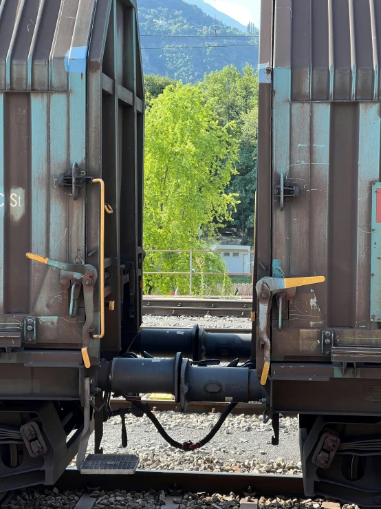 a pair of train cars sitting side by side